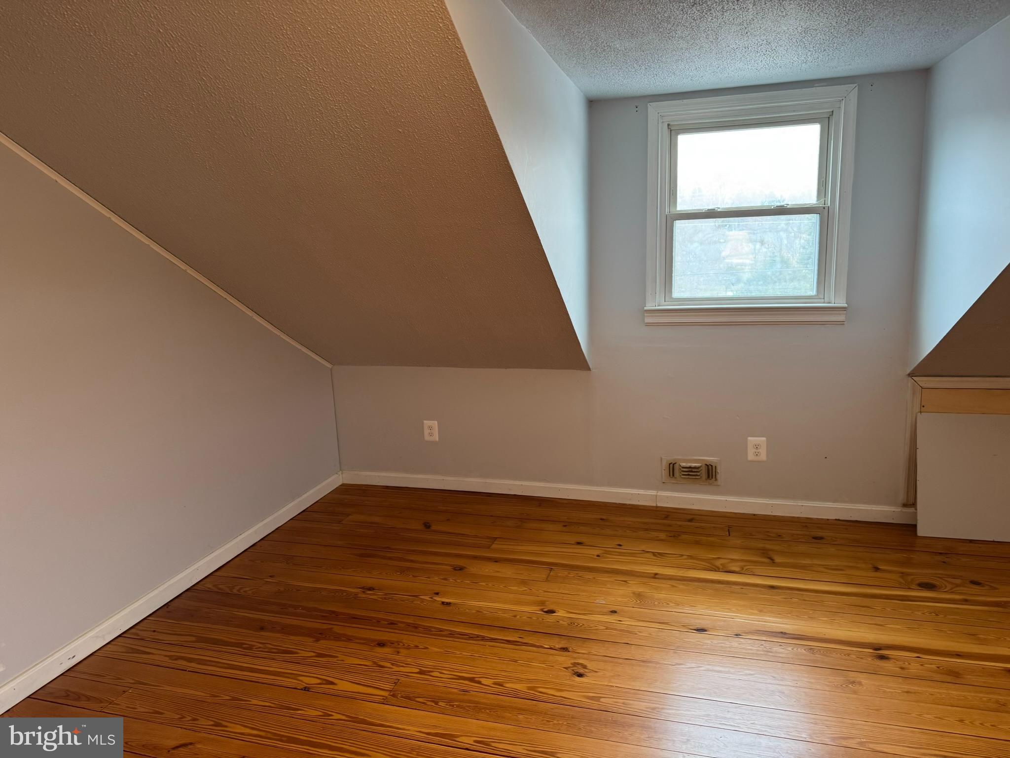 10012 Ellis Road Manassas, VA 20111 - Photo 27 of 71 a view of an empty room with wooden floor and a window
