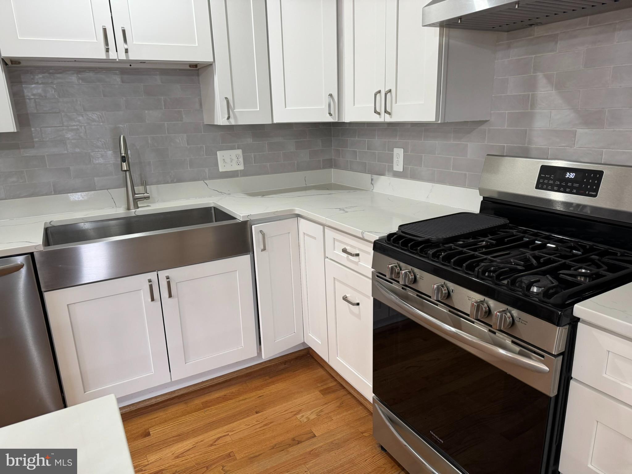 10012 Ellis Road Manassas, VA 20111 - Photo 4 of 71 a kitchen with granite countertop white cabinets and white appliances