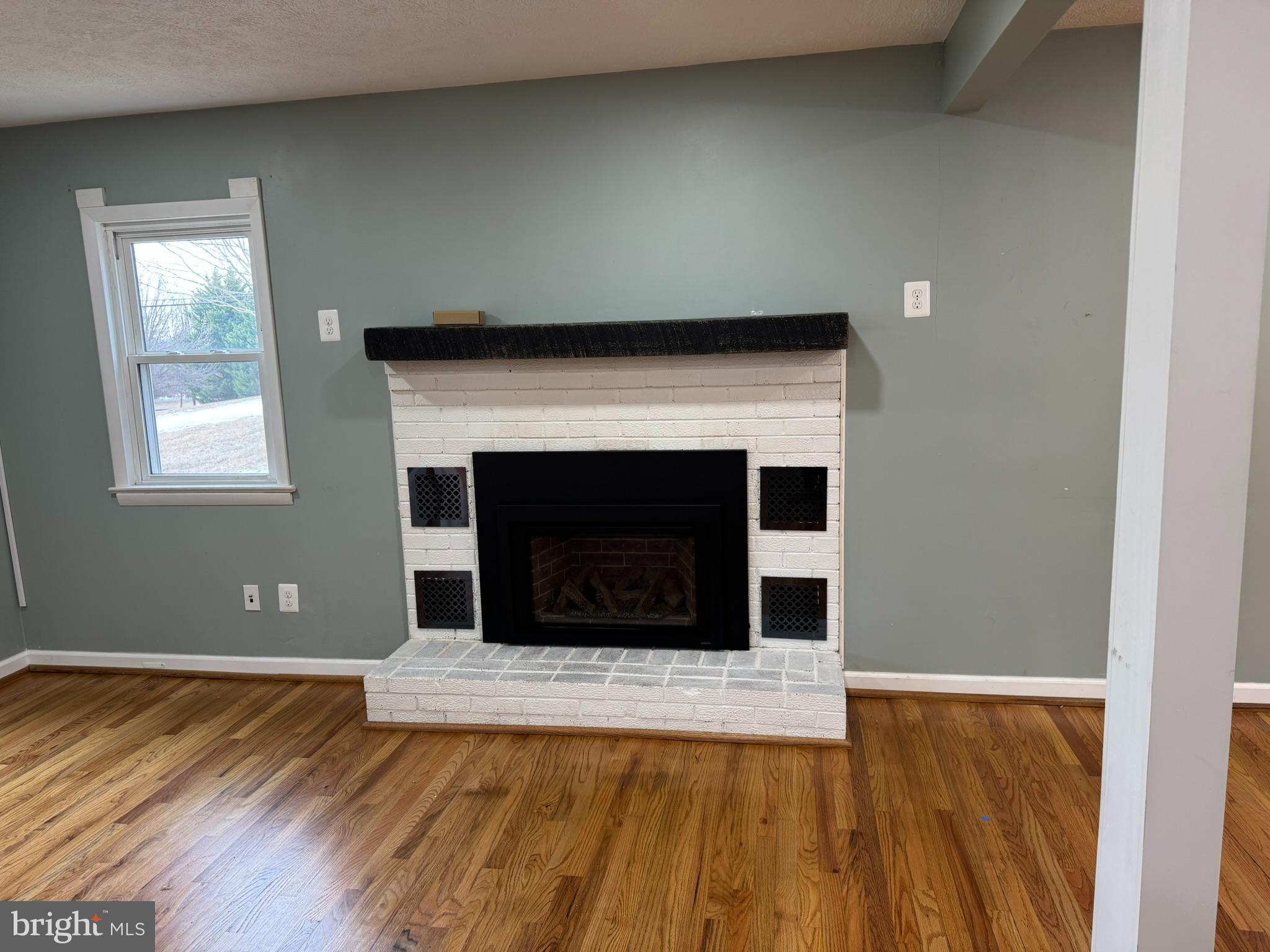 10012 Ellis Road Manassas, VA 20111 - Photo 5 of 71 a view of a livingroom with wooden floor and a fireplace