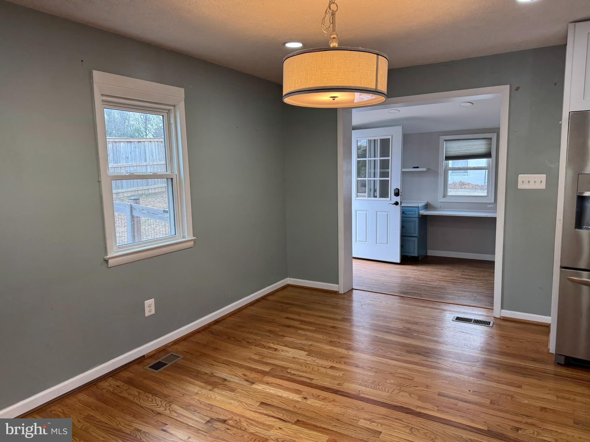 10012 Ellis Road Manassas, VA 20111 - Photo 8 of 71 an empty room with wooden floor and windows