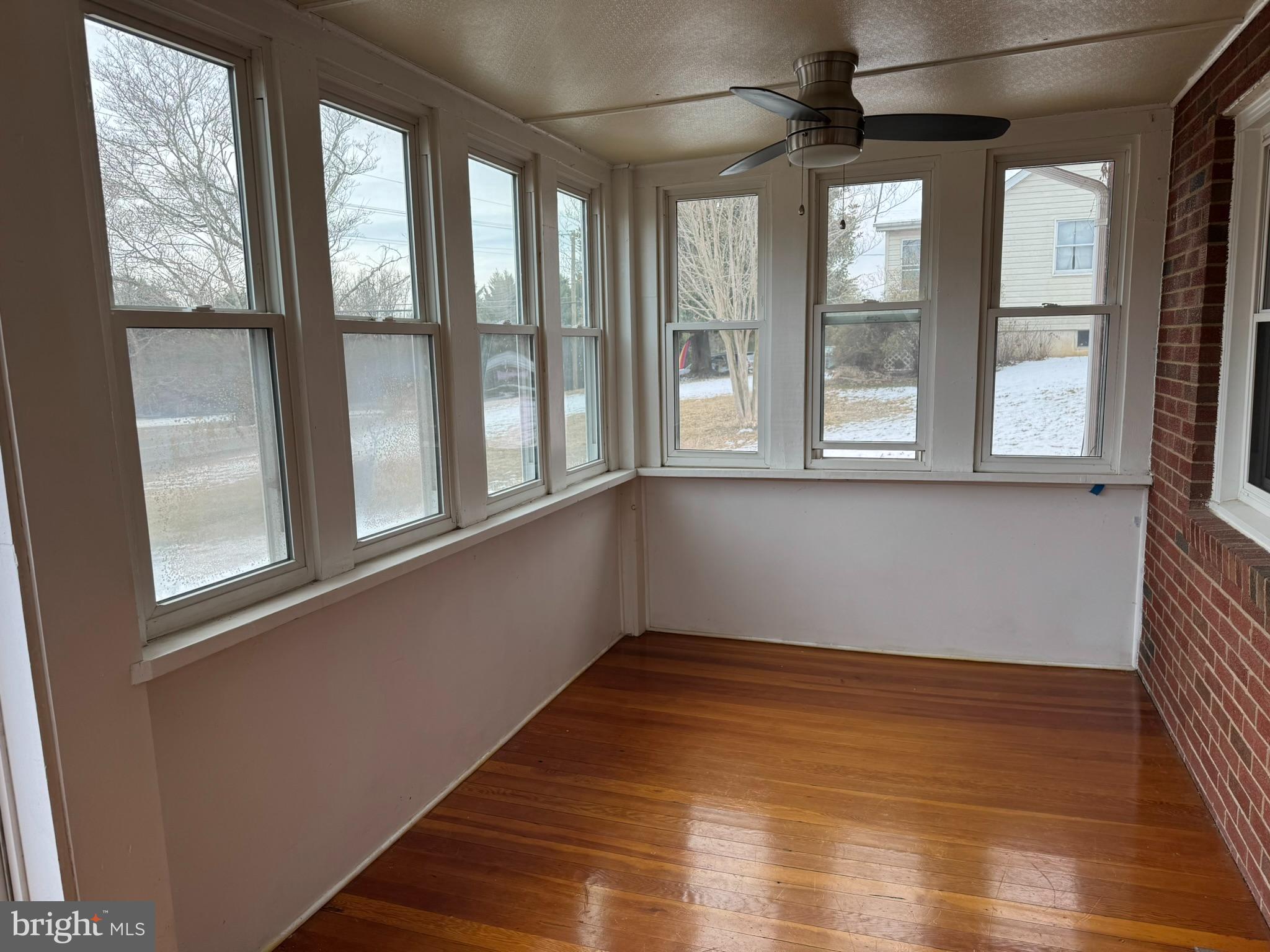 10012 Ellis Road Manassas, VA 20111 - Photo 9 of 71 a view of an empty room with wooden floor and a window