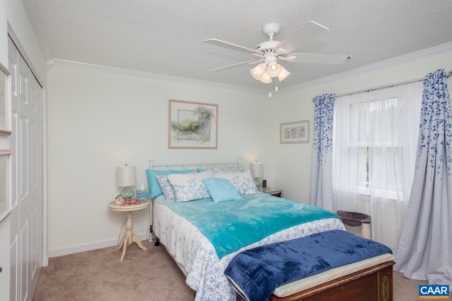 562 Millstone Court Charlottesville, VA 22901 - Photo 23 of 31 a bedroom with a bed and a chandelier