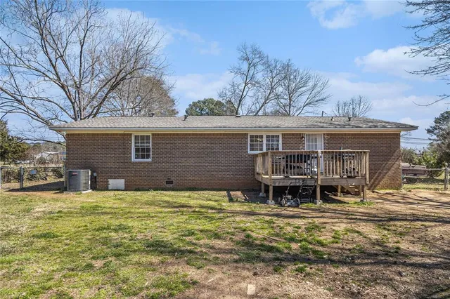 a backyard of a house with yard table and chairs