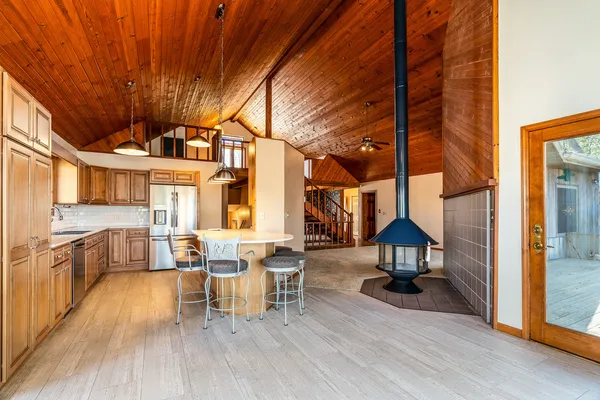a kitchen with stainless steel appliances granite countertop a stove a sink and a refrigerator