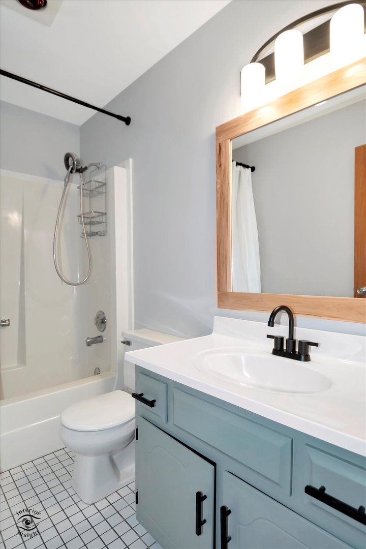 7507 West Tartan Road Frankfort, IL 60423 - Photo 17 of 25 a bathroom with a sink a toilet and a mirror