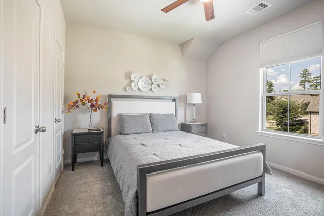 a bedroom with a bed and a window