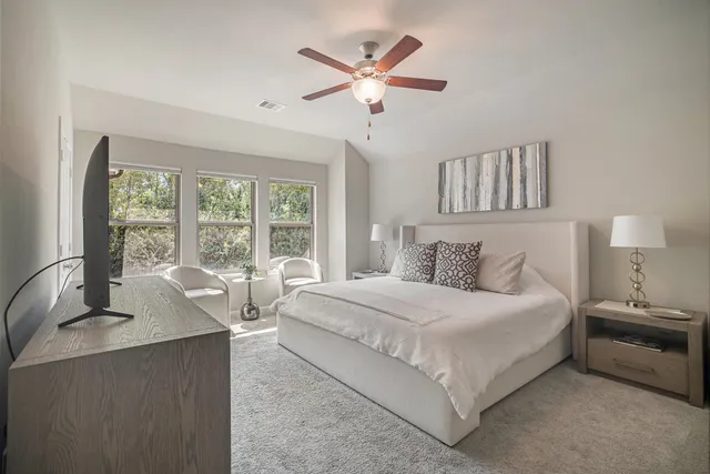 a bedroom with a large bed and a large window