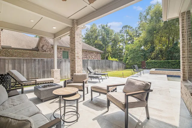 a view of a patio with a dining table and chairs with wooden floor