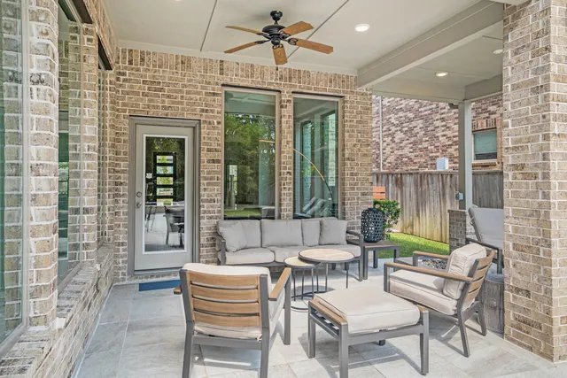 a balcony with furniture and a potted plant