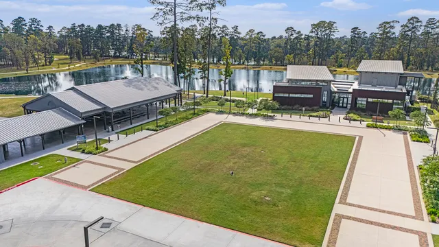 an aerial view of a house with swimming pool and a yard