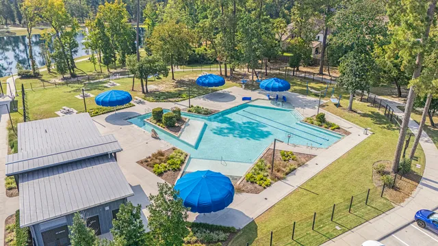 a view of swimming pool with chairs and potted plants