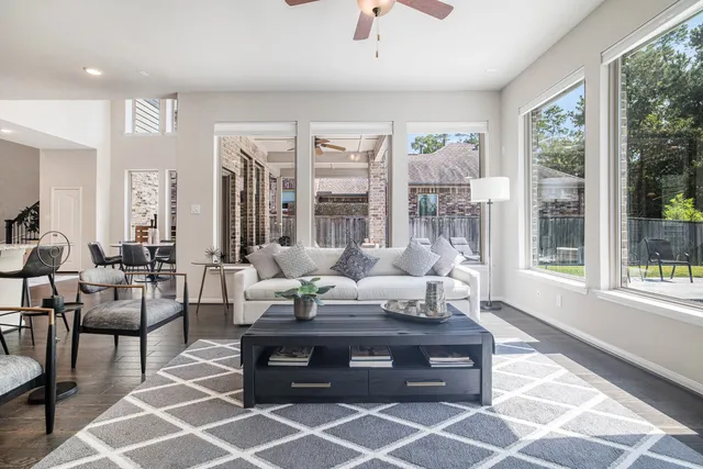 a living room with furniture and large windows