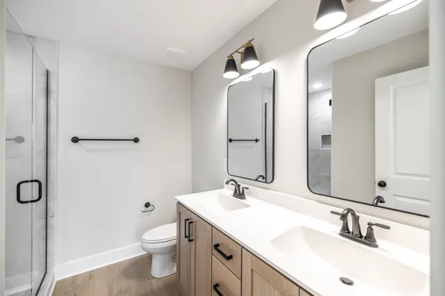 a bathroom with a double vanity sink mirror and
