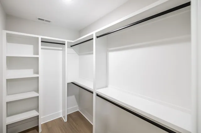 a view of a small space with wooden floor and a window