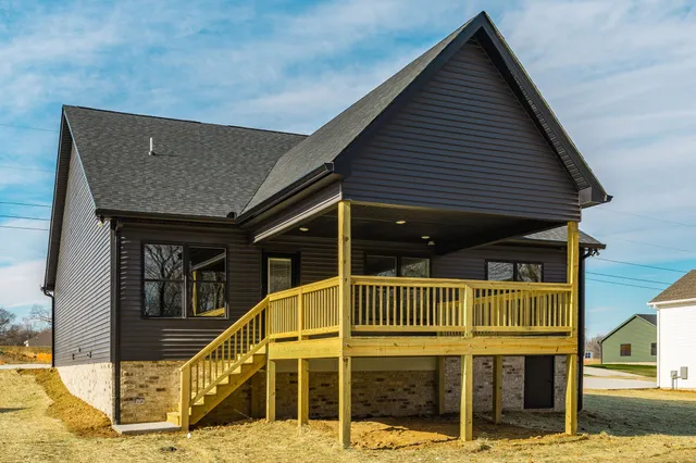 a view of a house with wooden fence