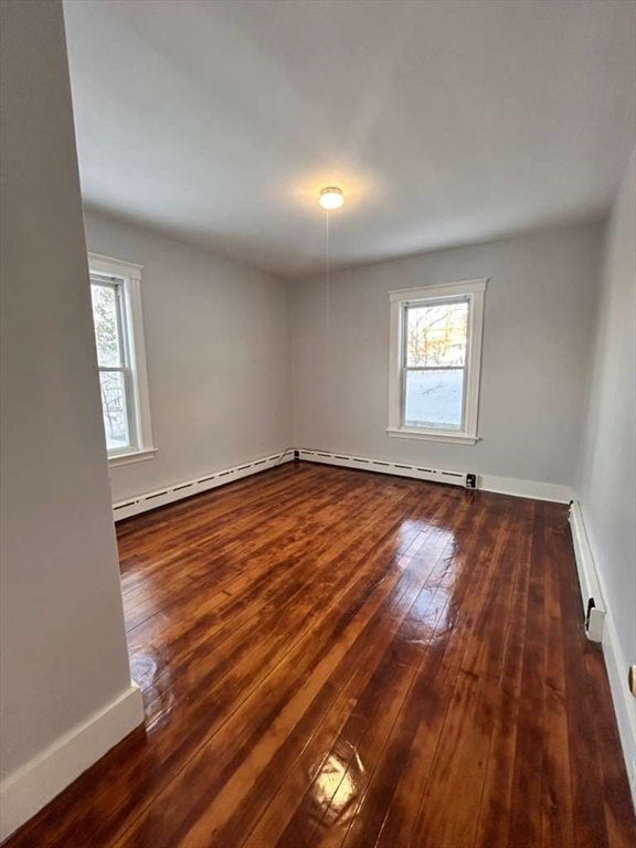 99 Cross Street Southbridge, MA 01550 - Photo 15 of 20 an empty room with wooden floor and windows