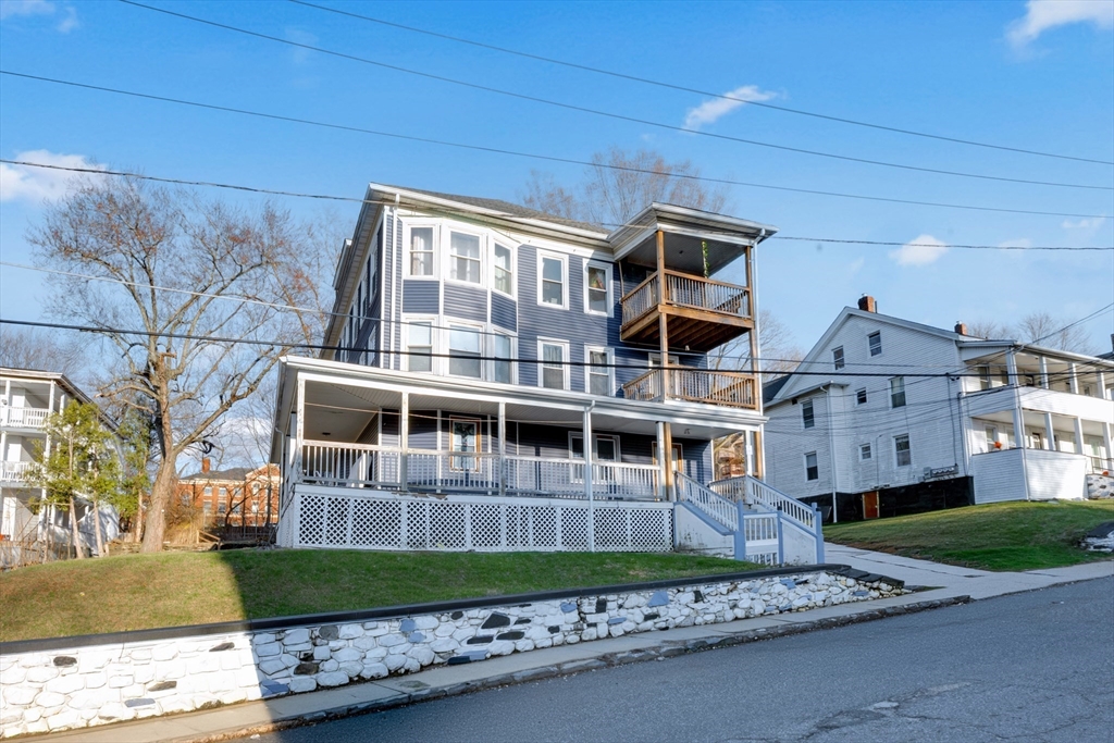 99 Cross Street Southbridge, MA 01550 - Photo 2 of 20 a front view of a house with a garden and plants