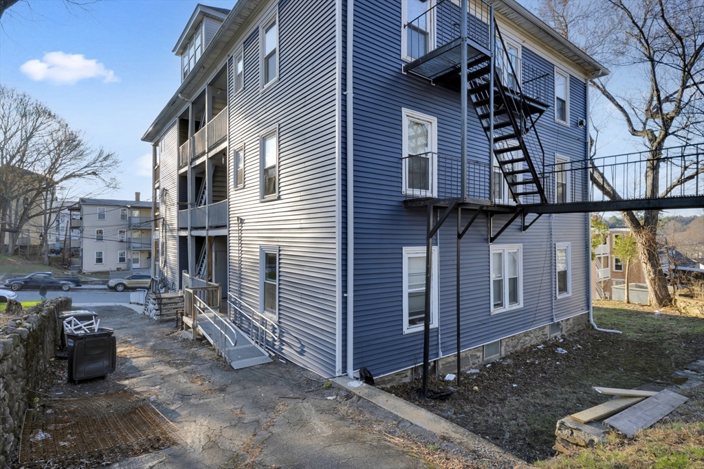 99 Cross Street Southbridge, MA 01550 - Photo 4 of 20 a view of a brick house with many windows
