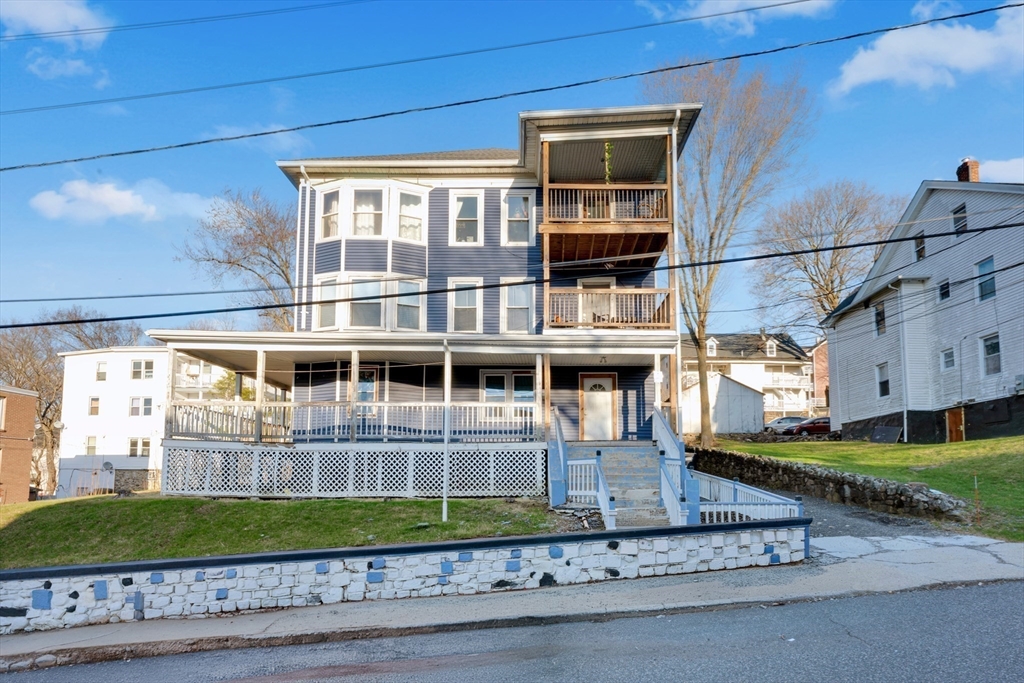 99 Cross Street Southbridge, MA 01550 - Photo 7 of 20 a front view of a house with a yard and potted plants