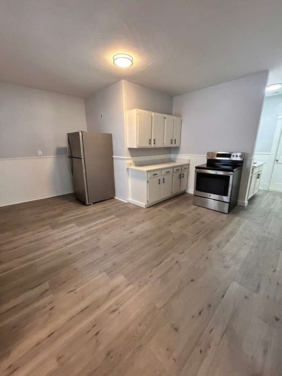 99 Cross Street Southbridge, MA 01550 - Photo 8 of 20 a kitchen with stainless steel appliances a stove and a refrigerator