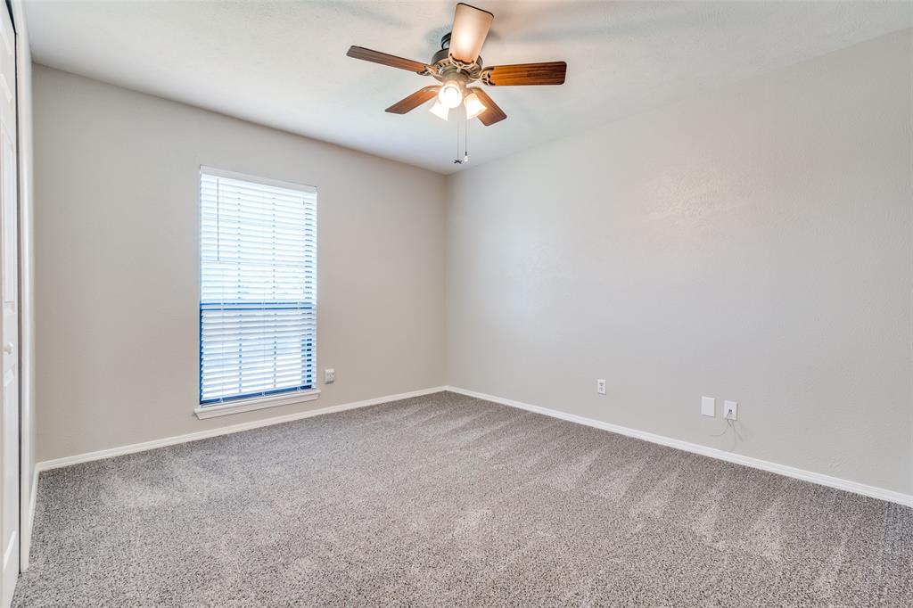 7617 Pebble Beach Drive Rowlett, TX 75088 - Photo 8 of 12 an empty room with windows and fan