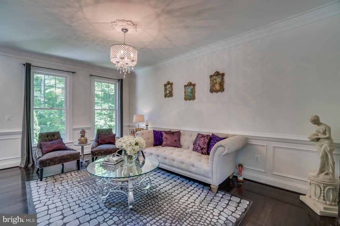 8585 Sinclair Mill Road Manassas, VA 20112 - Photo 6 of 38 Living room with wainscoting and chandelier