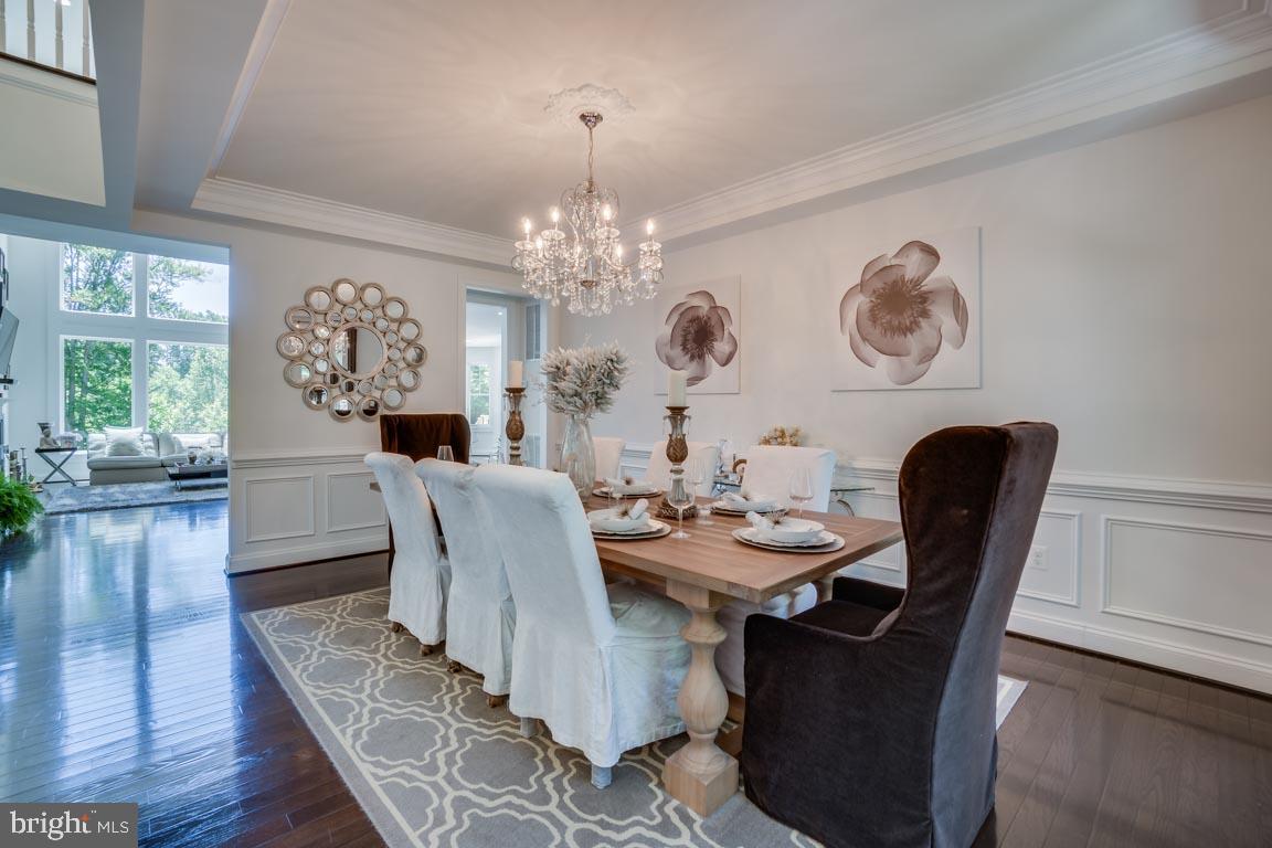 8585 Sinclair Mill Road Manassas, VA 20112 - Photo 9 of 38 Dining room with chandelier and wainscoting