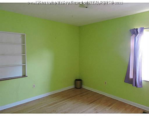 6243 Rosalind Road Huntington, WV 25705 - Photo 12 of 16 Main Level Bedroom. 2nd Bedroom with wall shelf and cedar lined closet. HW Floors.