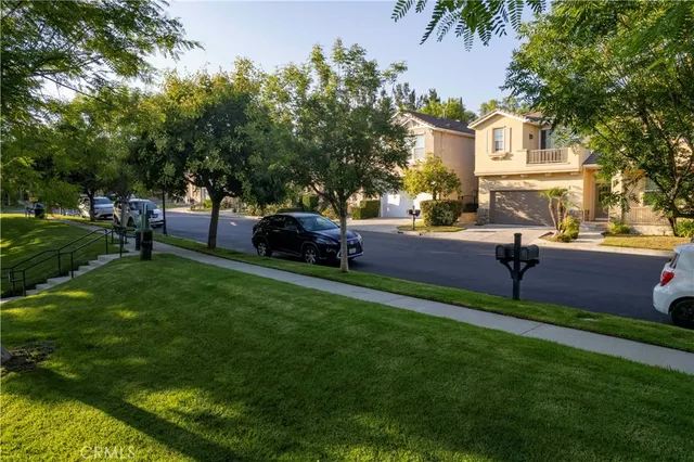 a view of a chandelier fan and wooden floor