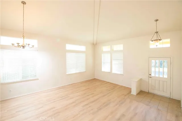 a view of a room with wooden floor and white walls