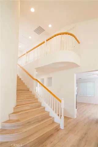 a large kitchen with stainless steel appliances granite countertop a lot of counter space and wooden floor