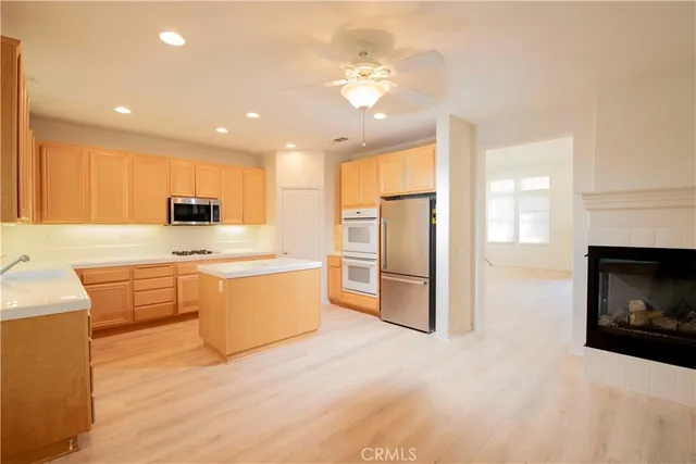 an empty room with windows and fireplace