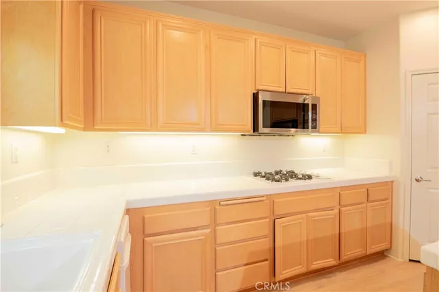 a white refrigerator freezer and a stove sitting inside of a kitchen
