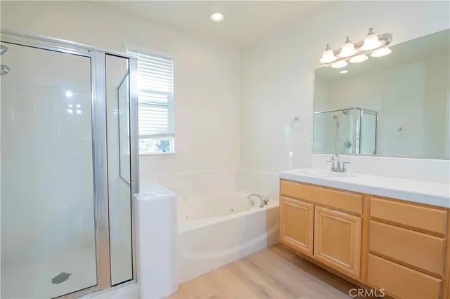a bathroom with a bathtub shower sink and mirror