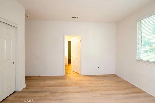 a front view of a house with a garden and yard