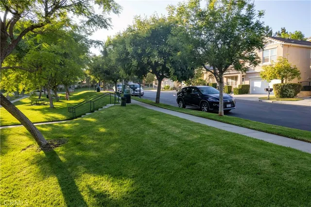 a view of a backyard with table and chairs and a slide