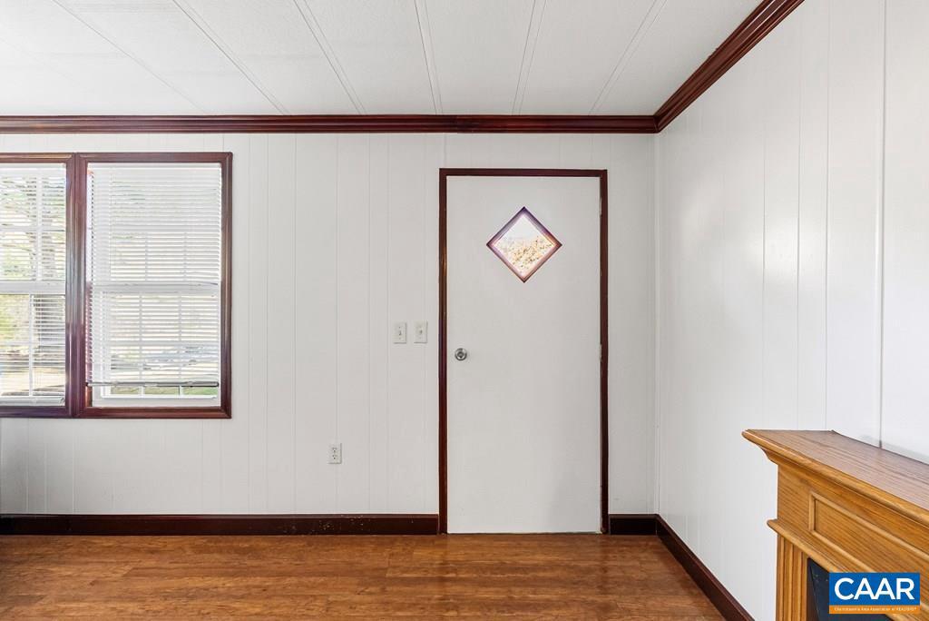1066 Stevens Cove Road Lovingston, VA 22949 - Photo 3 of 34 a view of a hallway with wooden floor