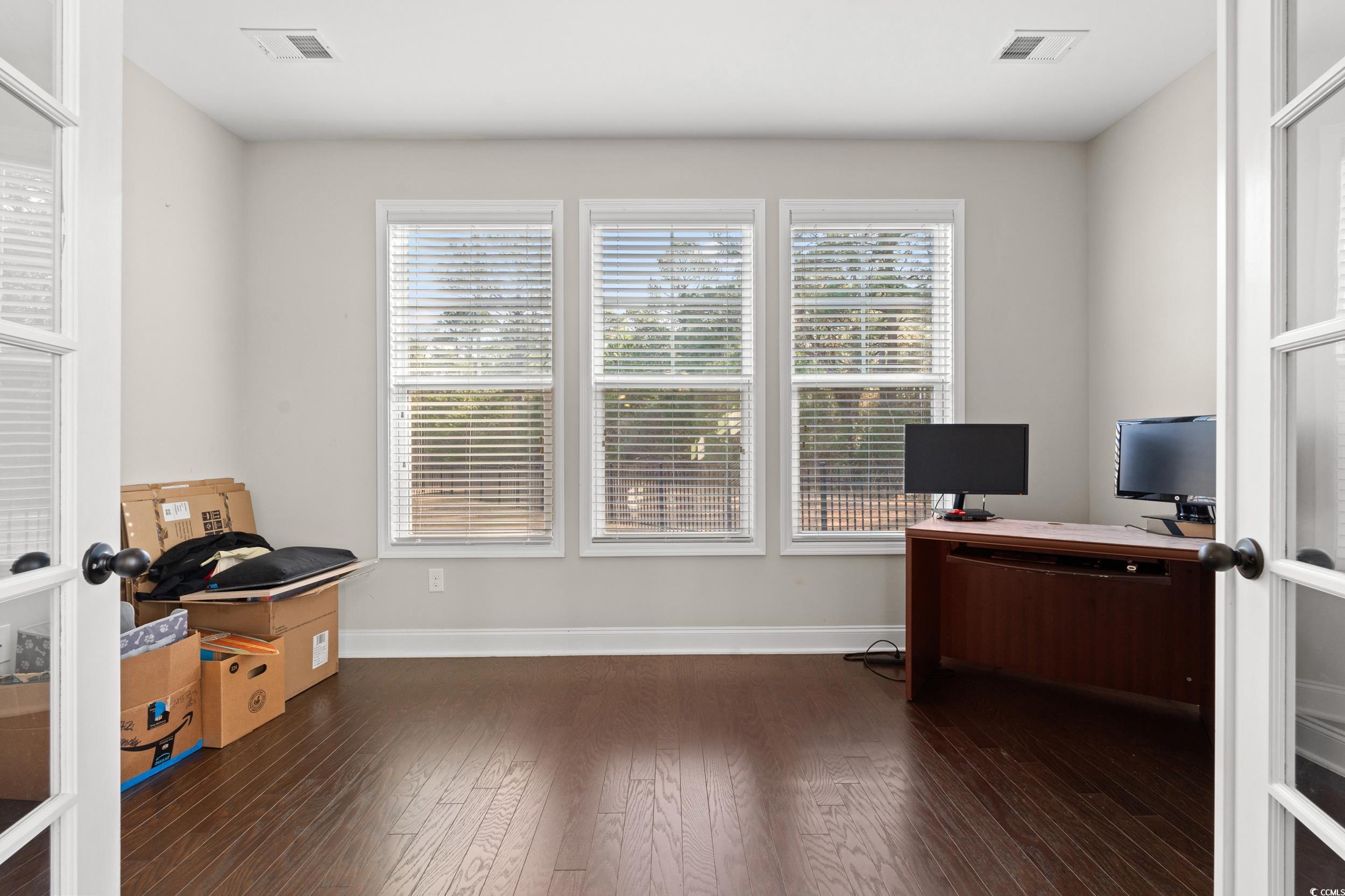 126 Viareggio Road Myrtle Beach, SC 29579 - Photo 13 of 40 Home office with french doors, healthy amount of natural light, and dark wood finished floors