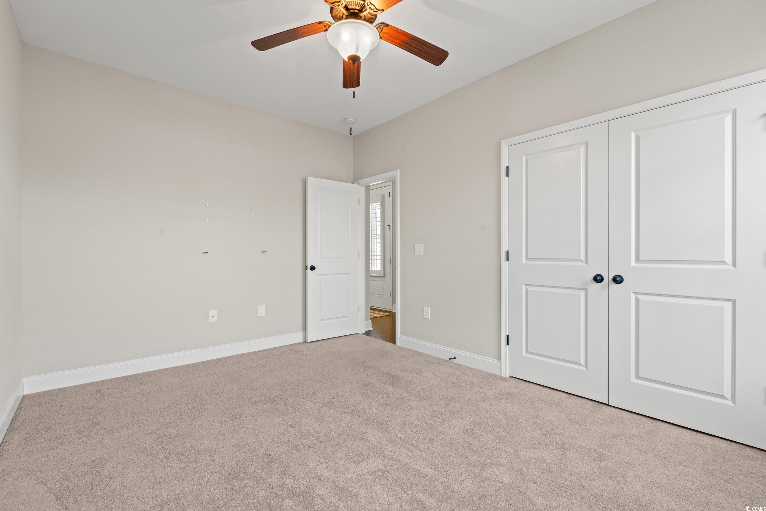 126 Viareggio Road Myrtle Beach, SC 29579 - Photo 17 of 40 Unfurnished bedroom with carpet flooring, a closet, and a ceiling fan