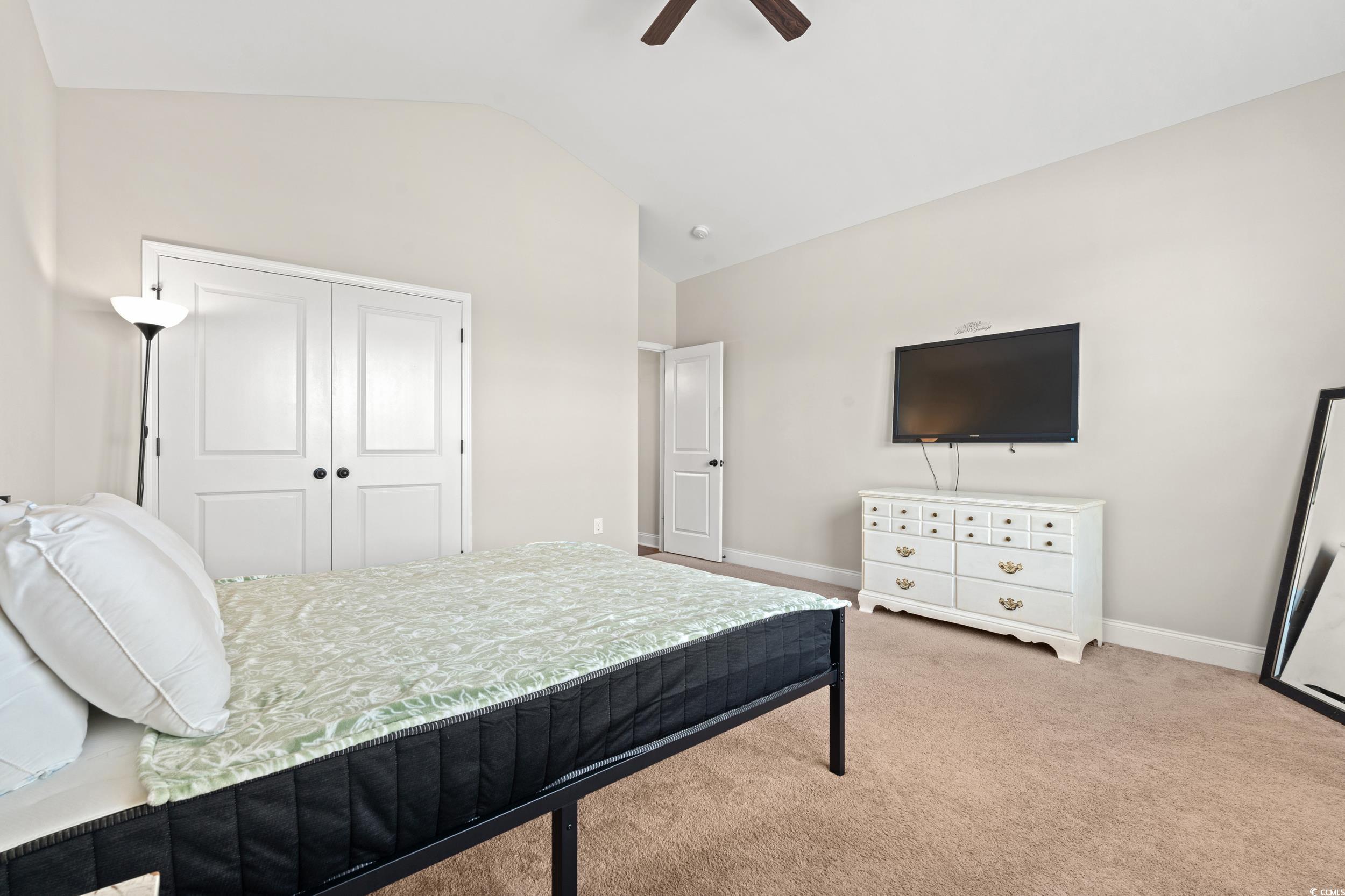 126 Viareggio Road Myrtle Beach, SC 29579 - Photo 19 of 40 Bedroom featuring vaulted ceiling, light carpet, ceiling fan, and a closet