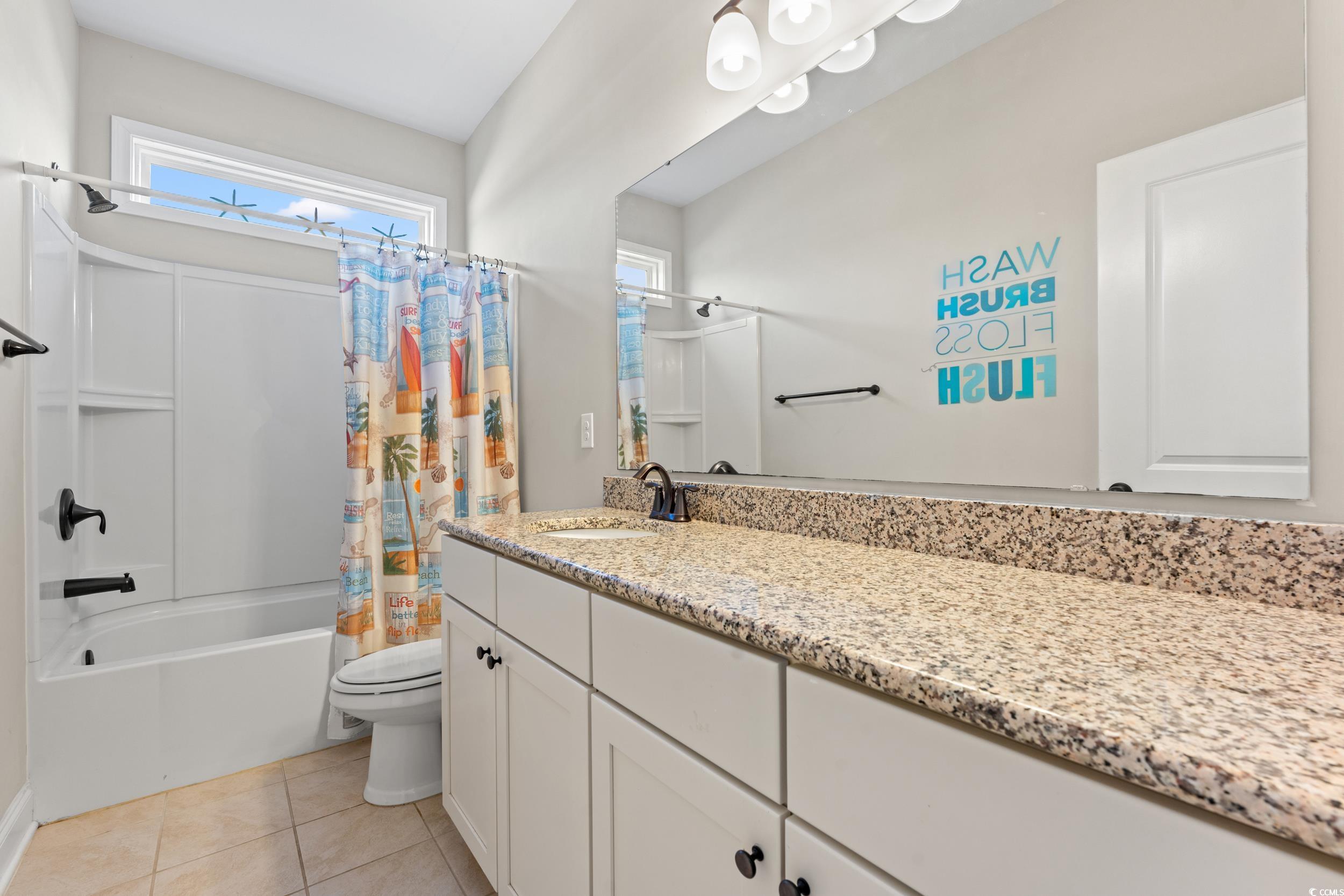 126 Viareggio Road Myrtle Beach, SC 29579 - Photo 23 of 40 Bathroom with shower / tub combo, vanity, and light tile patterned floors