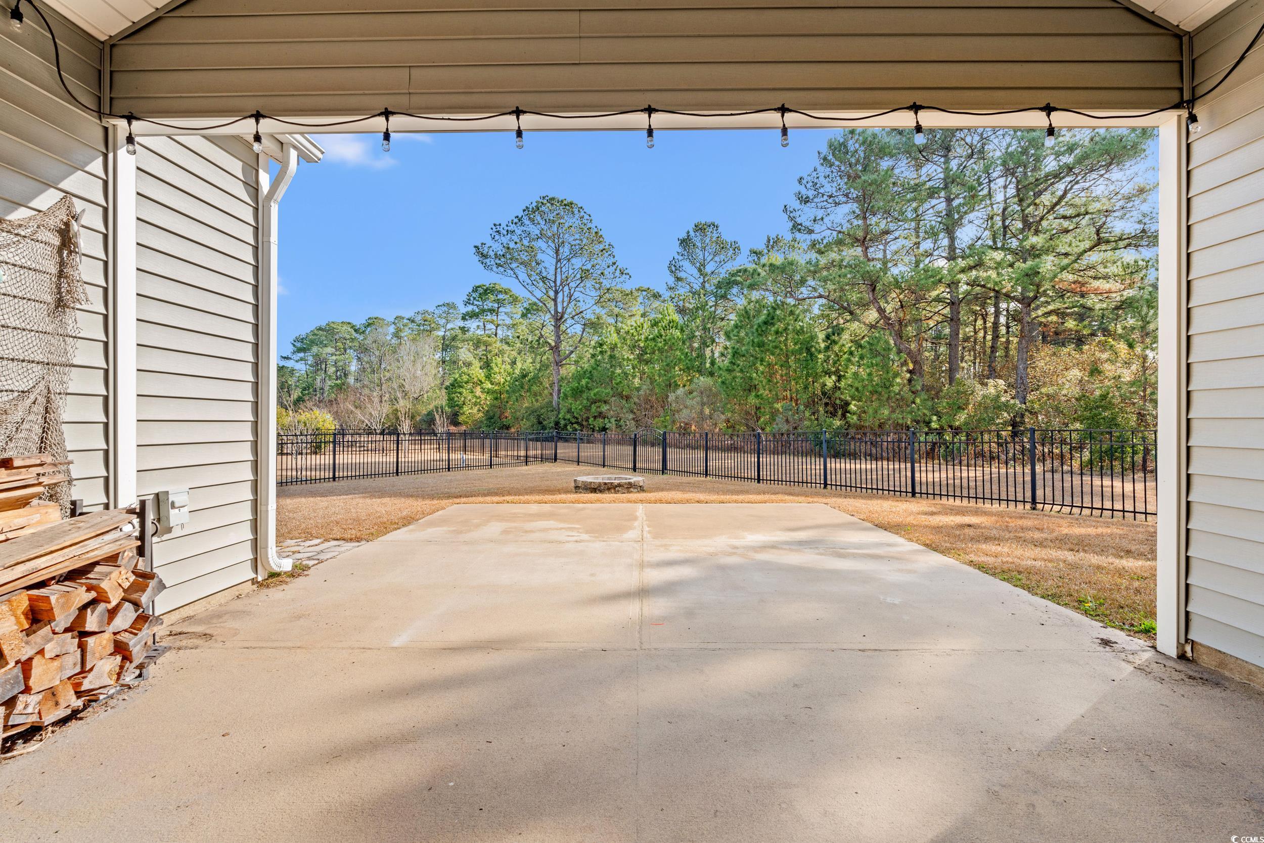 126 Viareggio Road Myrtle Beach, SC 29579 - Photo 28 of 40 Fenced backyard with a patio area and view of scattered trees