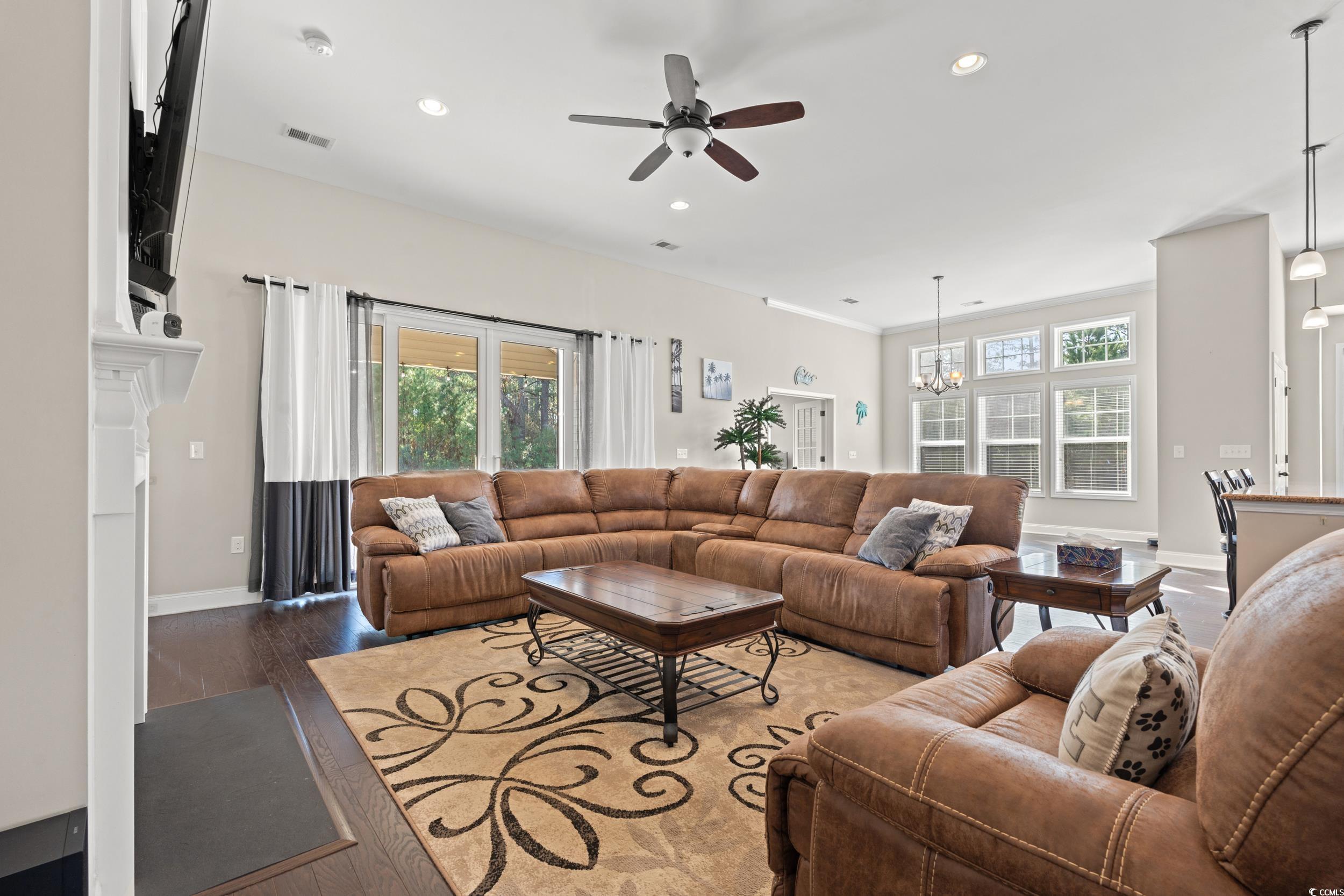 126 Viareggio Road Myrtle Beach, SC 29579 - Photo 9 of 40 Living area featuring a ceiling fan, recessed lighting, hardwood / wood-style floors, a chandelier, and a fireplace