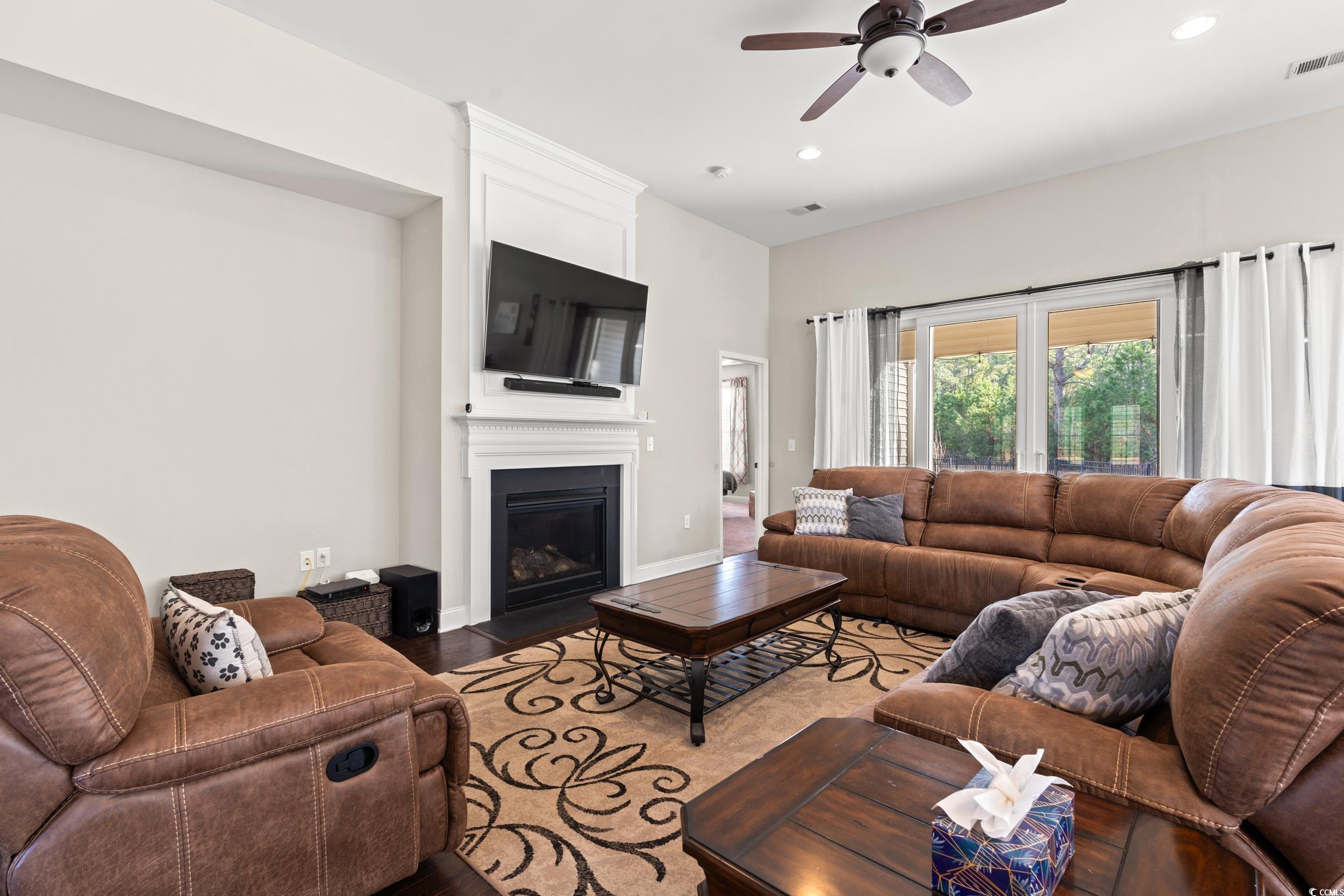 126 Viareggio Road Myrtle Beach, SC 29579 - Photo 10 of 40 Living room with a large fireplace, ceiling fan, wood finished floors, and recessed lighting