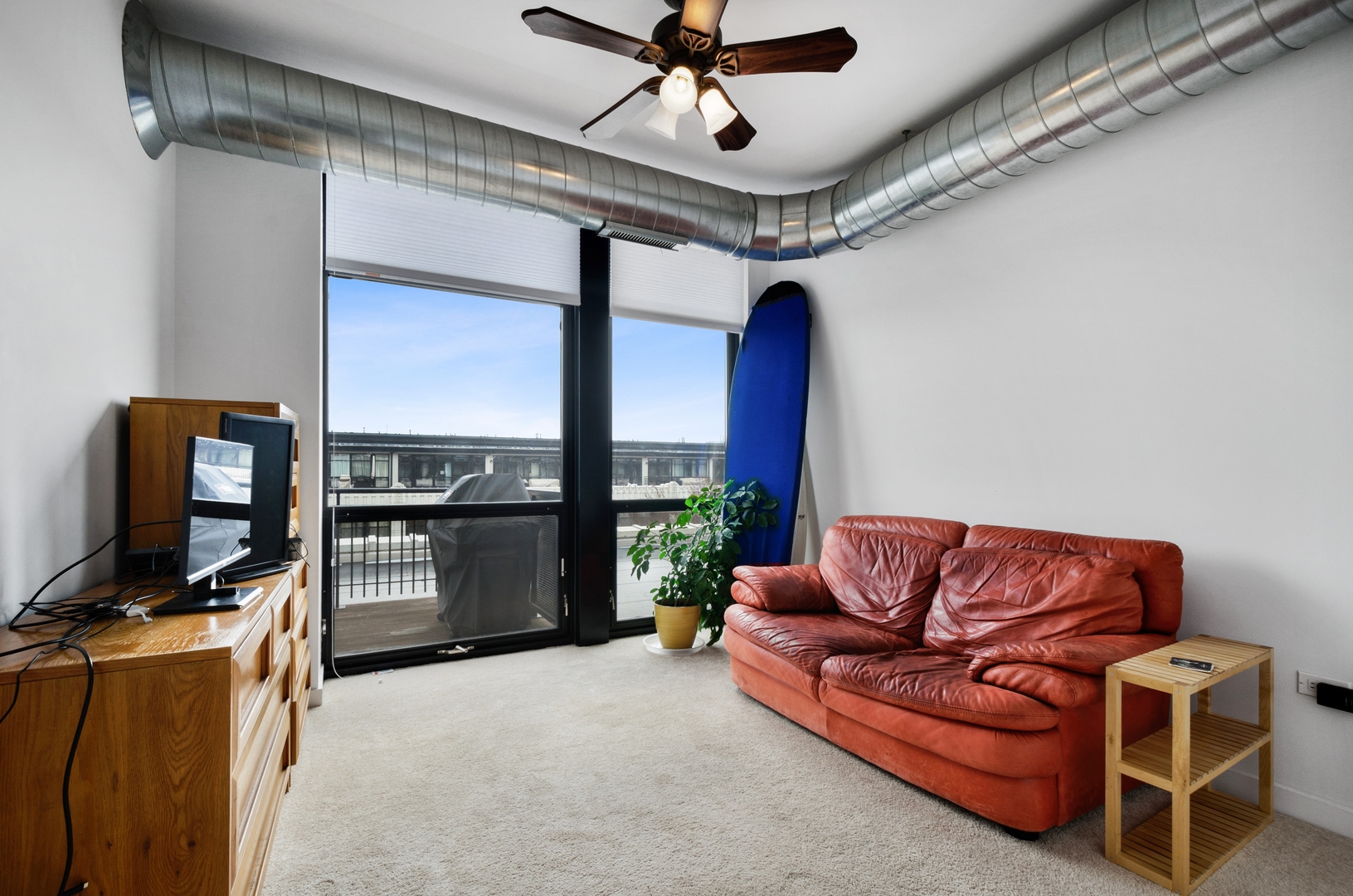 1110 West 15th Street, Unit 412 Chicago, IL 60608 - Photo 11 of 19 a living room with furniture a ceiling fan and a rug