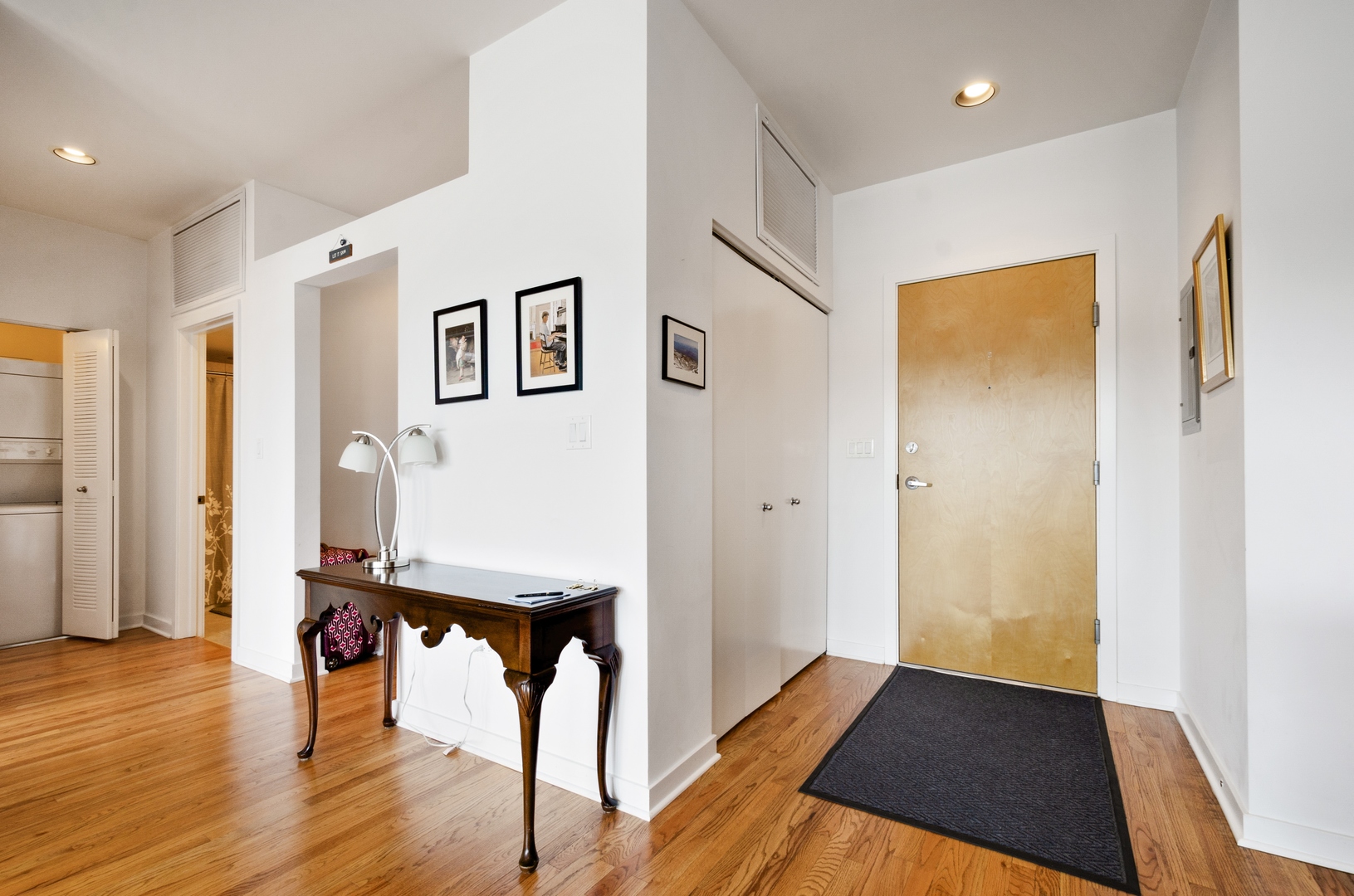 1110 West 15th Street, Unit 412 Chicago, IL 60608 - Photo 3 of 19 a view of a hallway with wooden floor and furniture