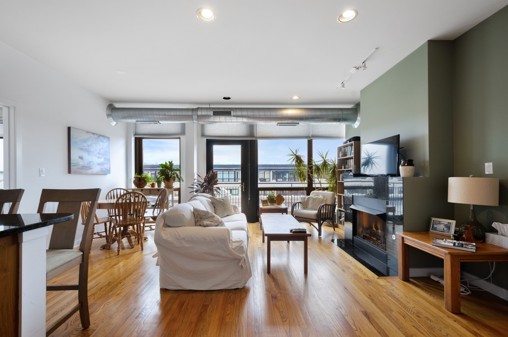 1110 West 15th Street, Unit 412 Chicago, IL 60608 - Photo 4 of 19 a living room with furniture and a wooden floor