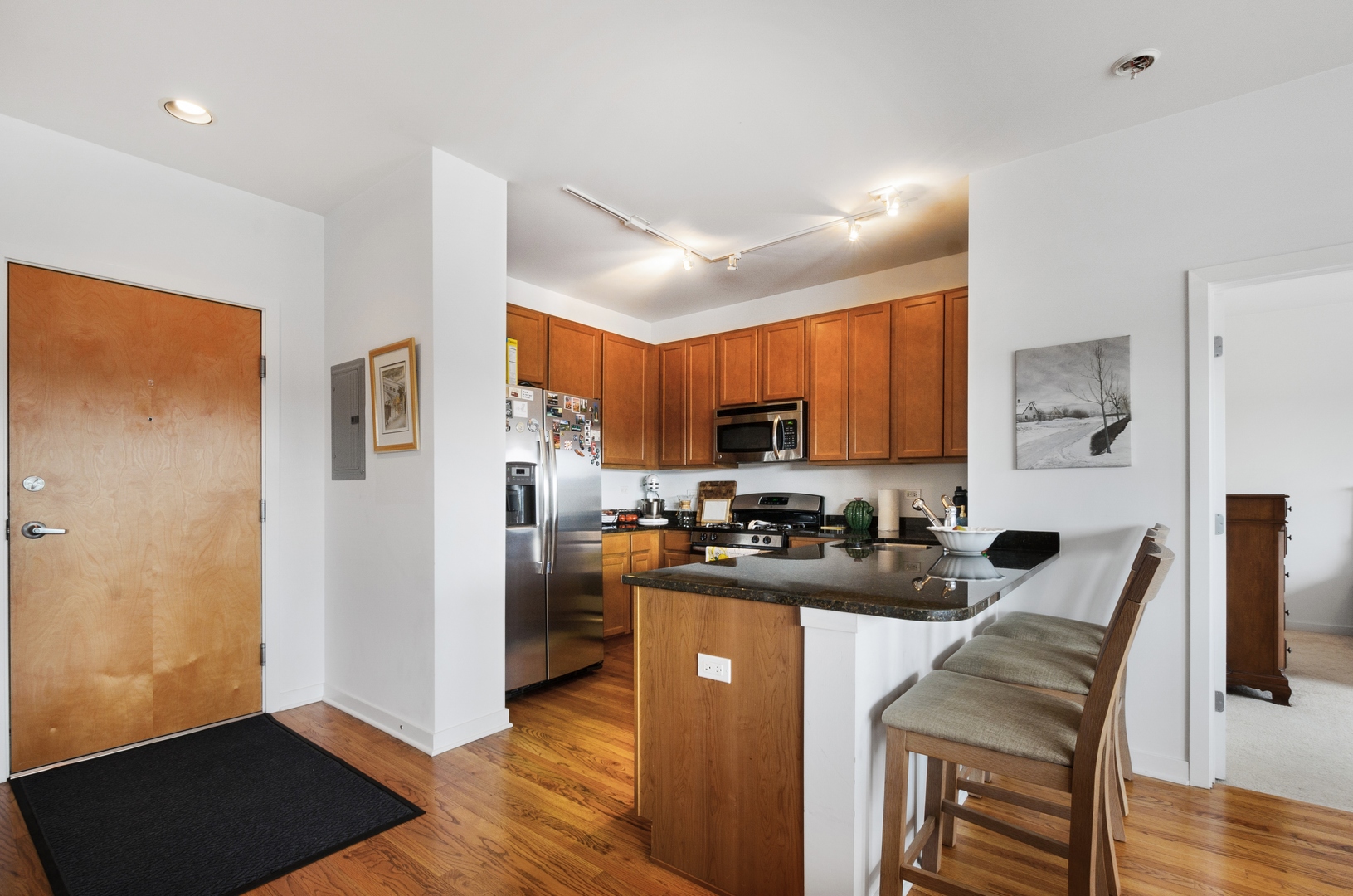 1110 West 15th Street, Unit 412 Chicago, IL 60608 - Photo 8 of 19 a kitchen with stainless steel appliances granite countertop a refrigerator stove microwave and sink
