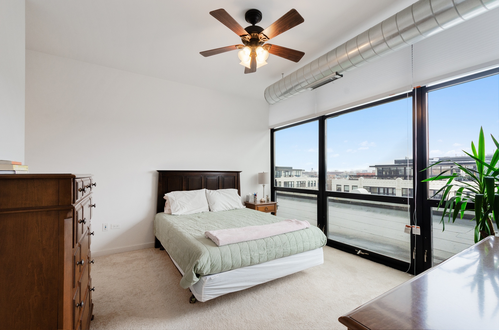 1110 West 15th Street, Unit 412 Chicago, IL 60608 - Photo 9 of 19 a bedroom with a bed and large glass walk in closet