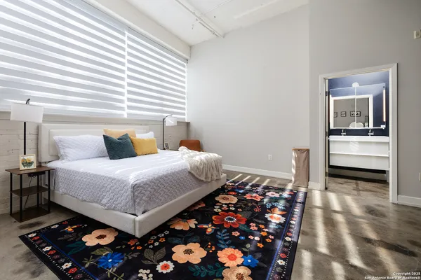 a bedroom with bed and a couch